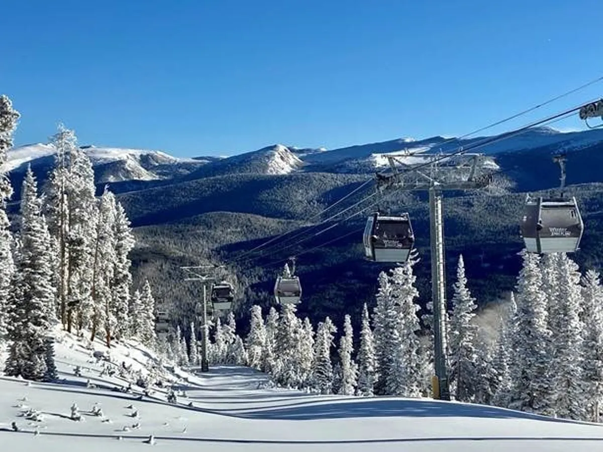 A panoramic shot of ski gondolas moving above snow-covered trees with a dramatic mountain landscape, capturing the thrill and beauty of local winter sports. The scene is alive with activity and adventure, connecting directly to the complimentary equipment and activities on offer.